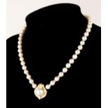 AN 18CT GOLD, PEARL AND DIAMOND NECKLACE The single pearl edged with diamonds in a geometric