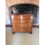 A 19TH CENTURY MAHOGANY SERPENTINE CHEST The brushing slide above four graduating drawers, on