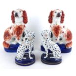 STAFFORDSHIRE, A PAIR OF LATE VICTORIAN/EARLY EDWARDIAN POTTERY MODELS OF SEATED KING CHARLES