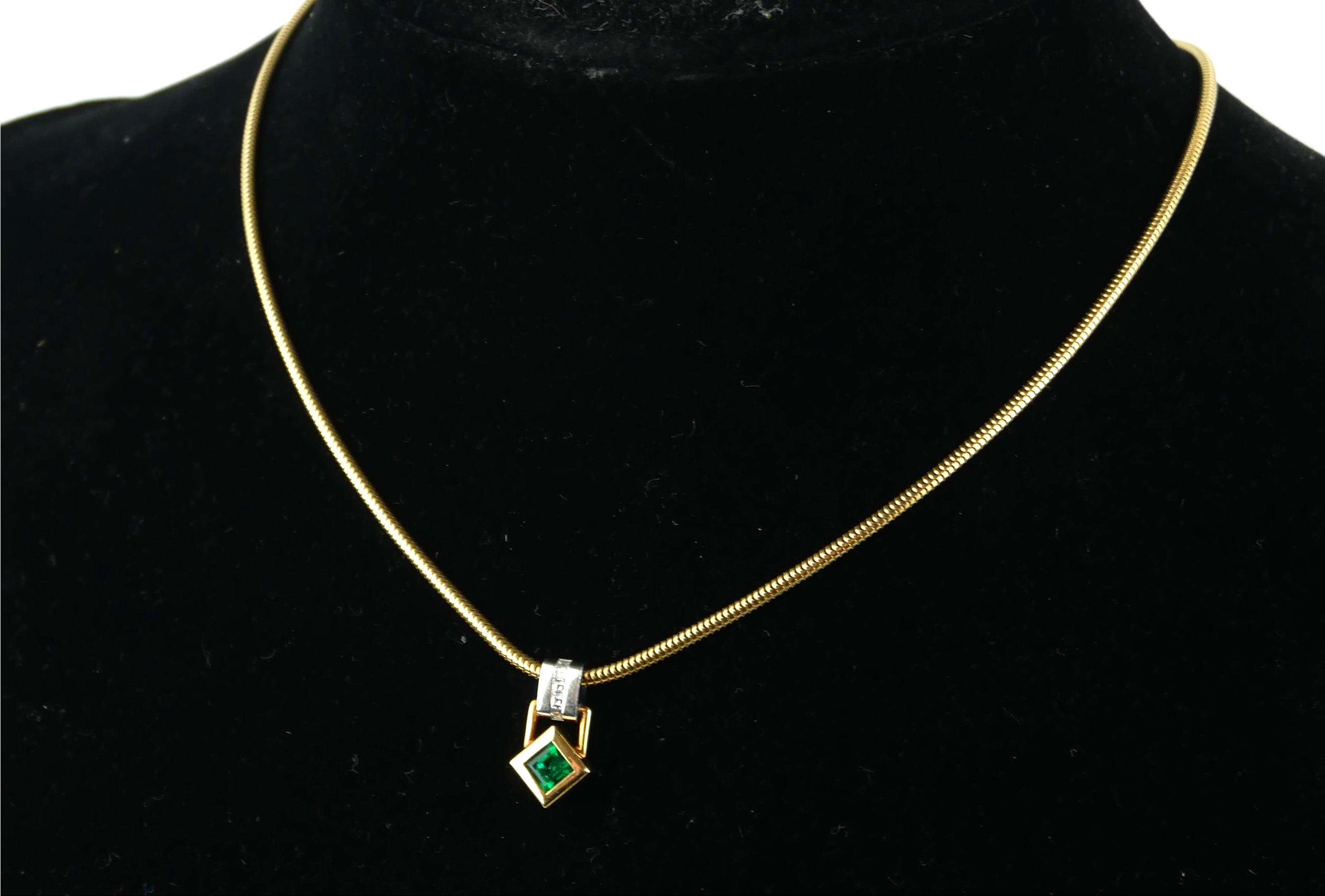 AN 18CT GOLD, EMERALD AND DIAMOND PENDANT.