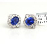 A PAIR OF 18CT WHITE GOLD AND SAPPHIRE EARRINGS Each having an oval cut sapphire edged with an