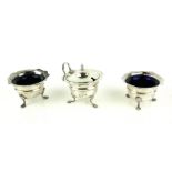 A VICTORIAN SILVER THREE PIECE CRUET SET Each piece having a blue glass liner, hallmarked