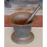 A LARGE 19TH CENTURY CAST IRON PESTLE AND MORTAR Classical bell form, on a circular base. (approx