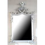 A ROCOCO DESIGN SILVERED FRAMED MIRROR With pierced floral cartouches above a silver plate. (95cm