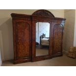 HEAL & SON, LONDON AN IMPRESSIVE BURR WALNUT BREAKFRONT TRIPLE WARDROBE With domed top cornice above