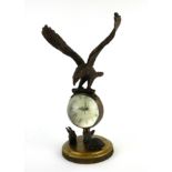 A BRONZE GLOBE CLOCK Mounted with an eagle above two rabbits. (21cm) Condition: good