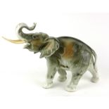 ROYAL DUX, DUCHOV, A MID 20TH CENTURY CONTINENTAL PORCELAIN MODEL OF A STANDING ELEPHANT Painted