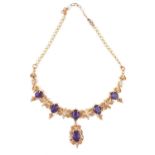 A 22CT GOLD, AMETHYST AND SEED PEARL NECKLACE Having six oval cut amethysts on fine fine pierced