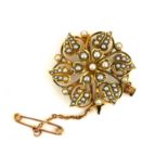 A VICTORIAN 15CT GOLD AND SEED PEARL BROOCH The arrangement of seed pearls forming a flower head