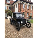 A 1925 MODEL T FORD PICK UP Black, convertible, four cylinder engine, wooden spoke wheels.