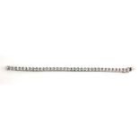 AN 18CT WHITE GOLD AND DIAMOND BRACELET Having a single row of round cut diamonds, together with a
