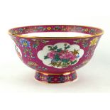 A CHINESE PORCELAIN BOWL Decorated with flowers within a scrolled puce border, bearing a six