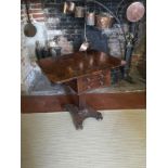 A WILLIAM IV ROSEWOOD DROP LEAF SIDE TABLE With two real and two false drawers, raised on a tapering