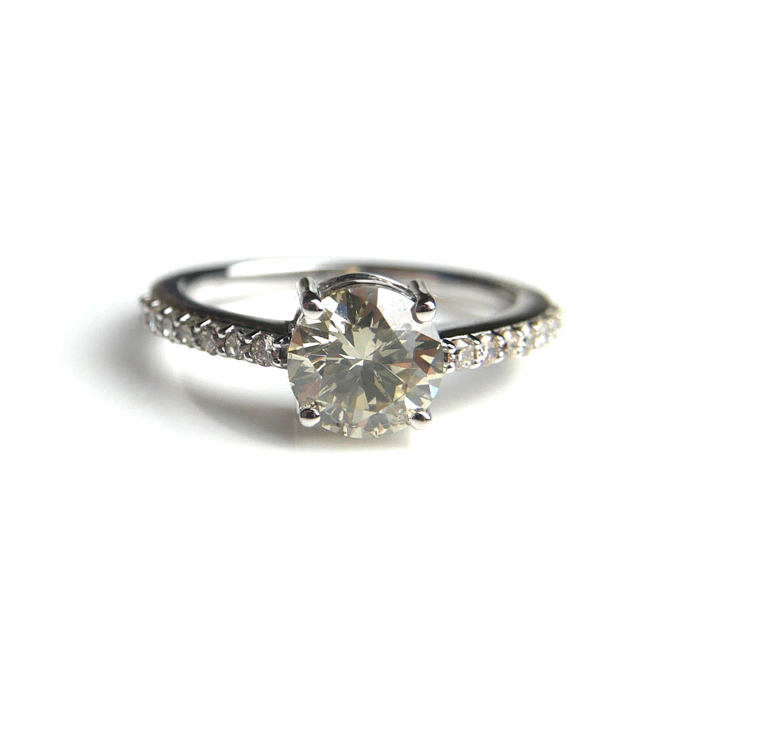 AN 18CT WHITE GOLD AND SOLITAIRE DIAMOND RING Flanked by diamond shoulders (size N/O). (approx total - Image 2 of 2