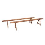 A PAIR OF 19TH CENTURY FRENCH FRUITWOOD BENCHES The single plank top raised on splayed turned