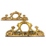 A PAIR OF EARLY 19TH CENTURY CARVED GILTWOOD ROCOCO DOOR PEDIMENT MIRRORS Decorated with scrolling