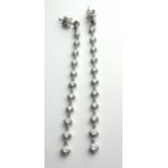A PAIR OF 18CT WHITE GOLD AND GRADUATED ROUND BRILLIANT CUT DIAMOND EARRINGS. (approx diamond weight