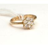 A 14CT GOLD AND DIAMOND CLUSTER RING The arrangement of round cut diamonds forming a flowerhead