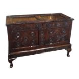 A JACOBEAN PERIOD NORTH COUNTRY OAK COFFER Carved with florets and lozenges, on a later stand. (
