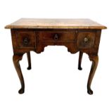 A GEORGE I WALNUT AND HERRINGBONE INLAY LOWBOY The moulded top above one frieze drawer flanked by
