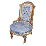A VICTORIAN MAHOGANY FRAMED NURSING CHAIR Button back floral upholstery, raised on turned legs on
