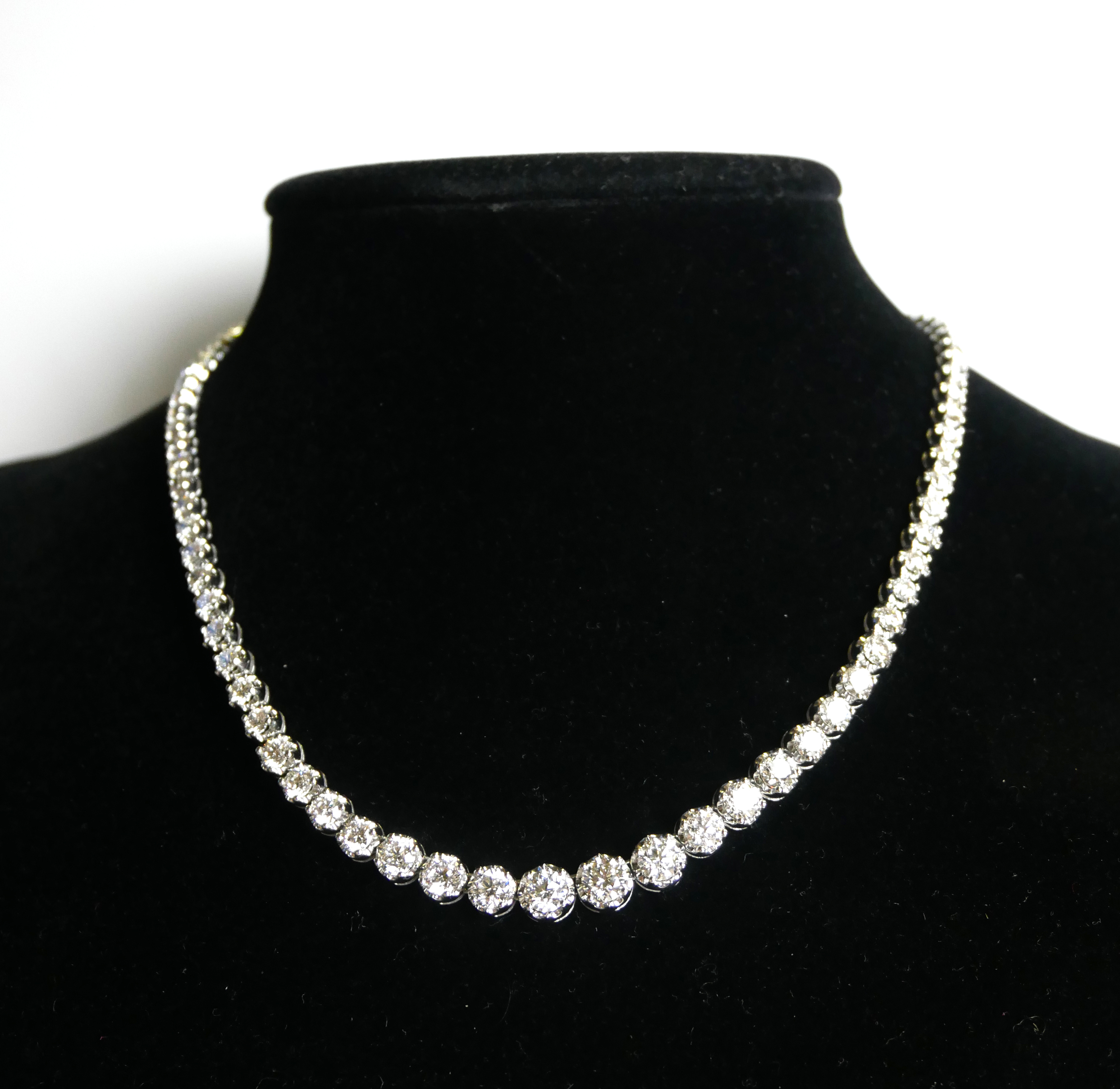 AN 18CT WHITE GOLD AND GRADUATED ROUND BRILLIANT CUT DIAMOND ETERNITY NECKLACE. (approx diamond