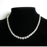AN 18CT WHITE GOLD AND GRADUATED ROUND BRILLIANT CUT DIAMOND ETERNITY NECKLACE. (approx diamond