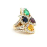 AN 18CT GOLD, DIAMOND AND GEM SET CLUSTER RING Having an arrangement of four pear cut stones, a