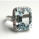 AN 18CT WHITE GOLD, AQUAMARINE AND DIAMOND RING (size N). (approx aquamarine weight 13.58ct)