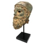 A LARGE ANTIQUE BRONZE FRAGMENT, A HEAD OF A BEARDED GREEK RIACE WARRIOR WEARING A HELMET Raised