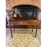 A GEORGIAN MAHOGANY FOLD-OVER TEA TABLE With a single drawer fitted with loop handles, raised on