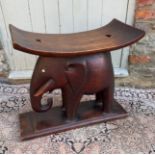 AN AFRICAN TRIBAL EBONISED WOOD ELEPHANT SEAT/STAND Raised on a rectangular base. (h 45cm x length