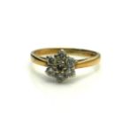 A VINTAGE 9CT GOLD AND DIAMOND DAISY CLUSTER RING Having an arrangement of round cut diamonds