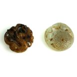 TWO CHINESE CARVED JADE ROUNDELS A brown jade dragon with pierced detail and a green jade roundel