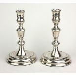 A PAIR OF GEORGE II STYLE DESK TOP HALLMARKED SILVER CANDLESTICKS With drum pattern nozzle tapered