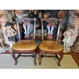 A RARE PAIR OF EARLY/MID 18TH CENTURY IRISH WALNUT STRETCHER CHAIRS With shaped rails centred with a