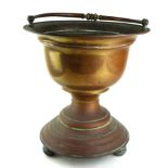 A LATE 19TH CENTURY COPPER PLANTER OF TROPHY FORM With swing handle, on bun feet. (diameter 35cm x