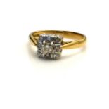 AN 18CT GOLD AND DIAMOND CLUSTER RING Having an arrangement of round cut diamonds forming a square