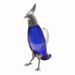 A BRISTOL BLUE GLASS A SILVER PLATE CARAFE FORMED AS A PARROT With amber glass eyes. (29cm)