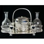 AN UNUSUAL SILVER PLATE AND ETCHED GLASS BISCUIT AND DECANTER SET Having a single carry handle,