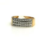 AN 18CT GOLD AND DIAMOND RING Three rows of round cut diamonds in a curved form mount (size S/T).