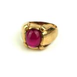 A VINTAGE 9CT GOLD AND RUBY GENT'S SIGNET RING Having an oval form cabochon cut ruby in a stepped