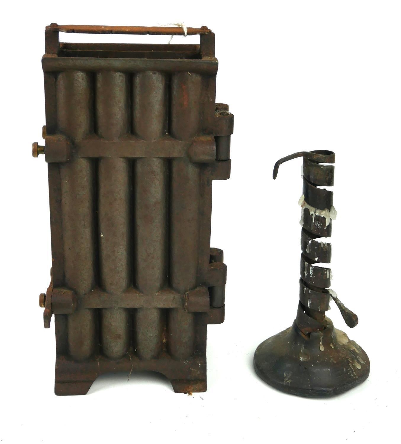 AN 18TH CENTURY IRON RUSH LIGHT HOLDER ON WOODEN BASE Along with a cast iron eight section candle