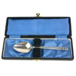 R.E. STONE, A MID CENTURY SILVER PRESENTATION SPOON Having a stepped finial and planished finish,