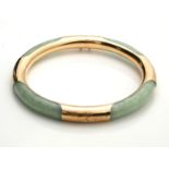 A 14CT GOLD AND CHINESE JADE BANGLE /BRACELET Circular carved green jade with 14ct gold overlay. (