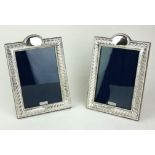 A PAIR OF SILVER RECTANGULAR PHOTOGRAPH FRAMES With an embossed beaded and gadrooned border, on