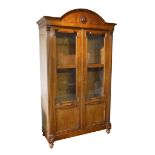 A 19TH CENTURY FRENCH WALNUT BIBLIOTEK With domed top cornice above two partial glazed doors