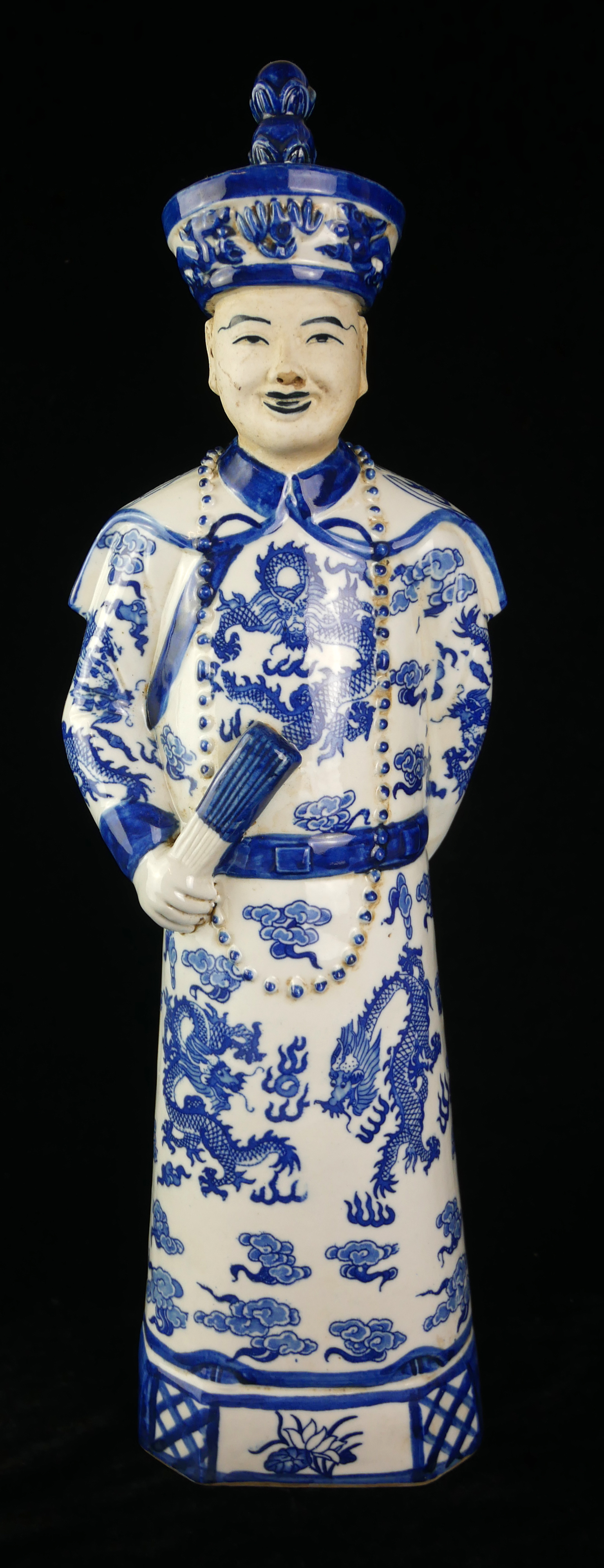 A CHINESE BLUE AND WHITE PORCELAIN EMPEROR FIGURE Standing pose wearing a robe with opposing dragons