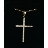 A 14CT GOLD AND DIAMOND CROSS PENDANT AND NECKLACE Set with a single row of diamonds to cross on a