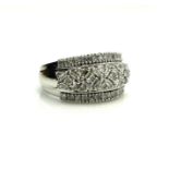 AN 18CT WHITE GOLD, BAGUETTE AND PAVÉ DIAMOND RING The arrangement of baguette cut diamonds